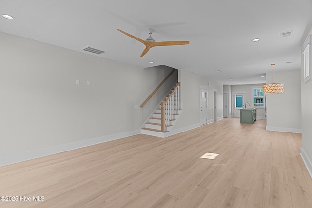 207 Spartanburg Ave Unit 1 & 2, Carolina Beach, NC 28428 - unfurnished living room with stairway, light wood-style flooring, recessed lighting, and ceiling fan