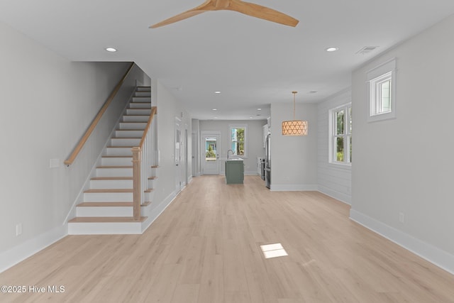 207 Spartanburg Ave Unit 1 & 2, Carolina Beach, NC 28428 - unfurnished living room with recessed lighting, stairs, light wood-style flooring, and ceiling fan