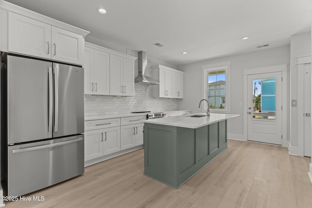 207 Spartanburg Ave Unit 1 & 2, Carolina Beach, NC 28428 - kitchen featuring freestanding refrigerator, wall chimney exhaust hood, light countertops, tasteful backsplash, and recessed lighting