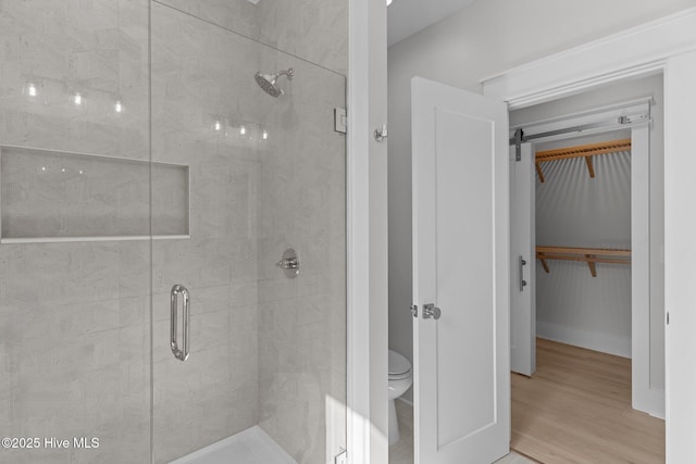 207 Spartanburg Ave Unit 1 & 2, Carolina Beach, NC 28428 - full bathroom featuring a shower stall, a spacious closet, and wood finished floors