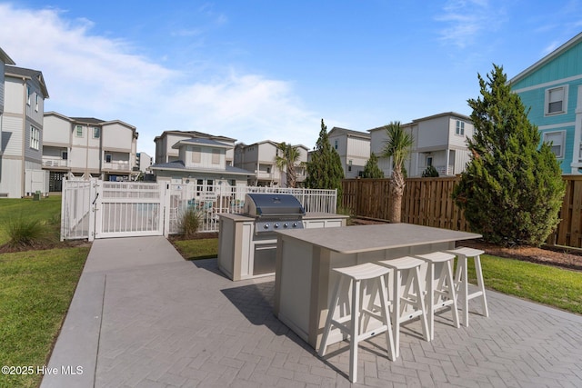 207 Spartanburg Ave Unit 1 & 2, Carolina Beach, NC 28428 - view of patio with area for grilling, a residential view, and a gate