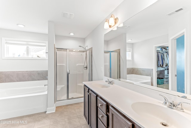 2526 Longleaf Pine Cir, Leland, NC 28451 - full bath featuring a bath, tile patterned floors, double vanity, a stall shower, and plenty of natural light
