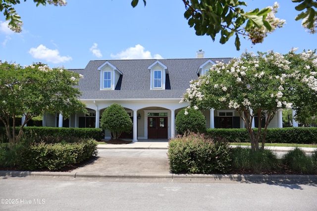 2526 Longleaf Pine Cir, Leland, NC 28451 - new england style home featuring driveway, a shingled roof, and a chimney