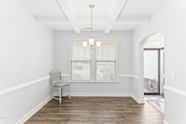 2526 Longleaf Pine Cir, Leland, NC 28451 - unfurnished room with coffered ceiling, dark wood finished floors, a chandelier, beam ceiling, and arched walkways