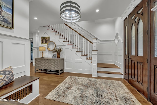 318 Cabbage Inlet Ln, Wilmington, NC 28409 - foyer featuring a decorative wall, stairs, wood finished floors, recessed lighting, and a chandelier