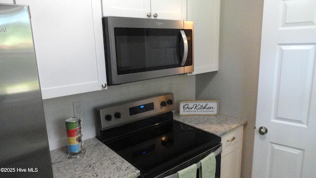 109 Lewis Ct, Havelock, NC 28532 - kitchen with appliances with stainless steel finishes, white cabinetry, tasteful backsplash, and light stone counters