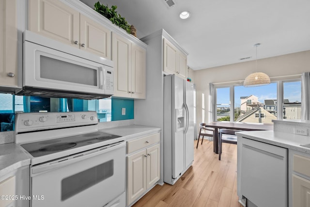 8202 5th Ave, North Topsail Beach, NC 28460 - kitchen with white appliances, light countertops, white cabinetry, hanging light fixtures, and recessed lighting