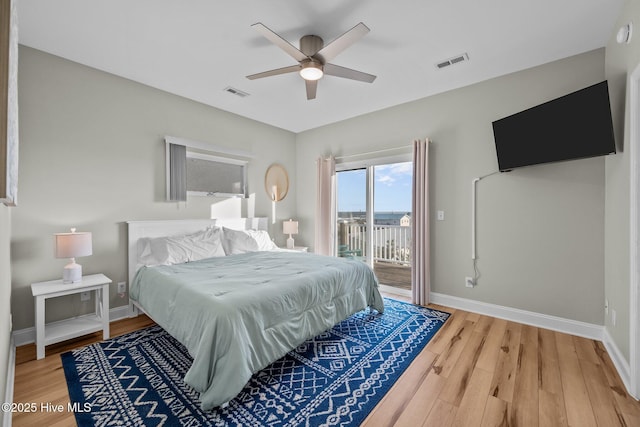 8202 5th Ave, North Topsail Beach, NC 28460 - bedroom featuring access to exterior, light wood-style flooring, and a ceiling fan