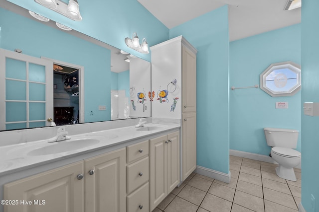 8202 5th Ave, North Topsail Beach, NC 28460 - bathroom with tile patterned floors, double vanity, and a closet