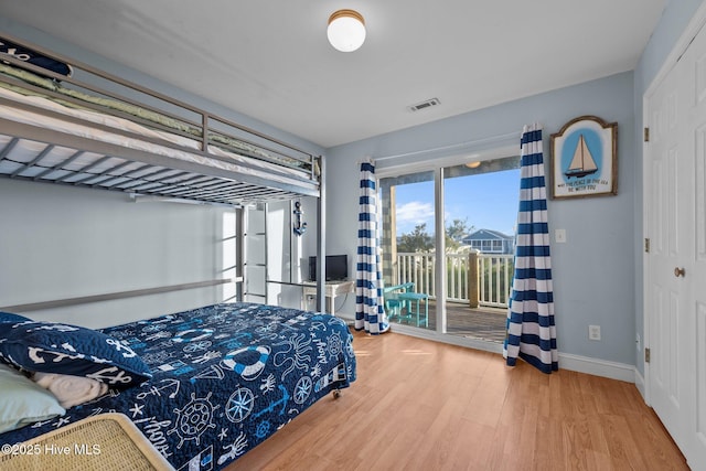 8202 5th Ave, North Topsail Beach, NC 28460 - bedroom featuring access to exterior and wood finished floors