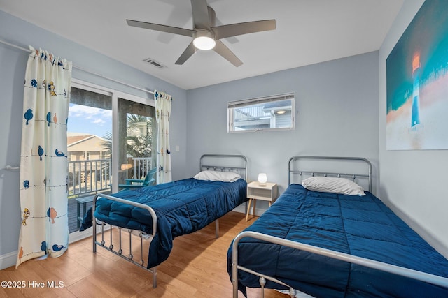 8202 5th Ave, North Topsail Beach, NC 28460 - bedroom featuring access to exterior, wood finished floors, and ceiling fan