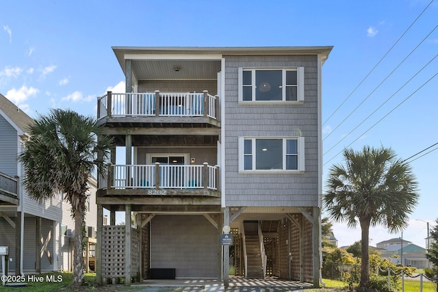 8202 5th Ave, North Topsail Beach, NC 28460 - view of front of home featuring a balcony and a carport