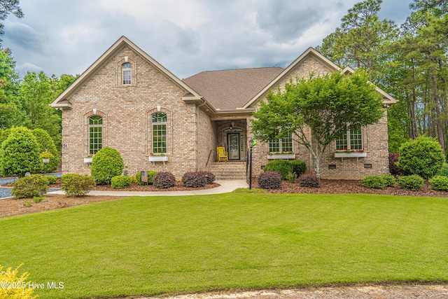 56 Kilbride Dr, Pinehurst, NC 28374 - view of front of house featuring brick siding, a front lawn, and a shingled roof