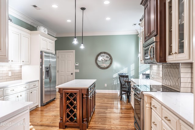 56 Kilbride Dr, Pinehurst, NC 28374 - kitchen with stainless steel appliances, crown molding, light wood-type flooring, backsplash, and hanging light fixtures