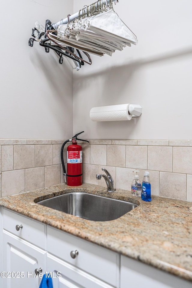 56 Kilbride Dr, Pinehurst, NC 28374 - kitchen featuring tasteful backsplash, white cabinetry, and light stone countertops
