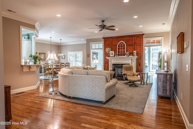 56 Kilbride Dr, Pinehurst, NC 28374 - living room with healthy amount of natural light, a ceiling fan, a fireplace, recessed lighting, and dark wood-type flooring