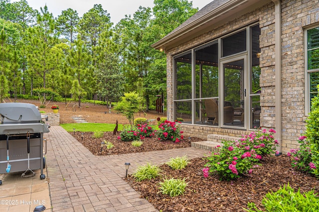 56 Kilbride Dr, Pinehurst, NC 28374 - view of patio with a sunroom, a grill, and view of scattered trees