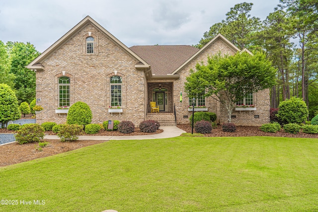 56 Kilbride Dr, Pinehurst, NC 28374 - view of front of house featuring a front yard, brick siding, a shingled roof, and crawl space