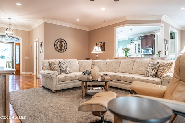 56 Kilbride Dr, Pinehurst, NC 28374 - living area with recessed lighting, ornamental molding, wood finished floors, a ceiling fan, and a chandelier