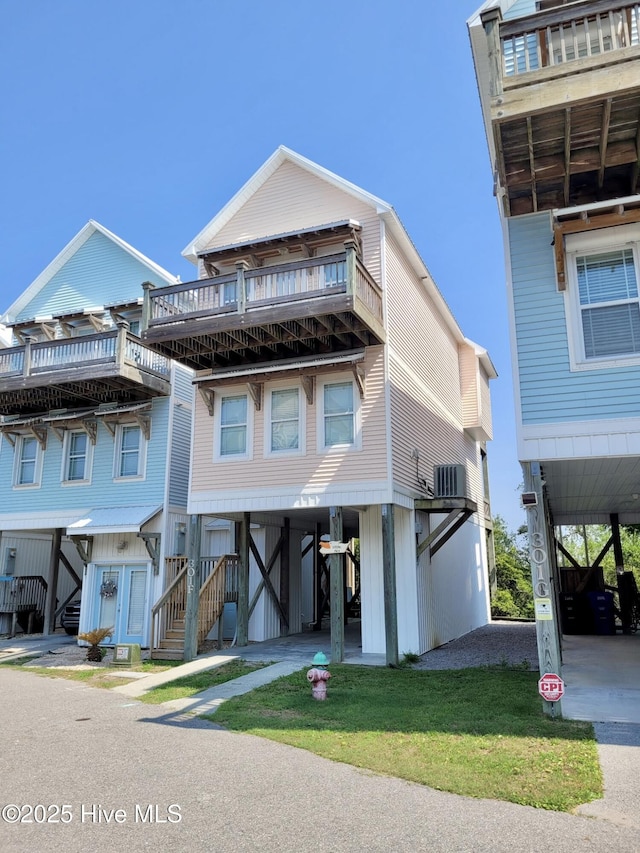 301 Mandalay Ct Unit F, Surf City, NC 28445 - view of front facade featuring a carport, a balcony, and stairway