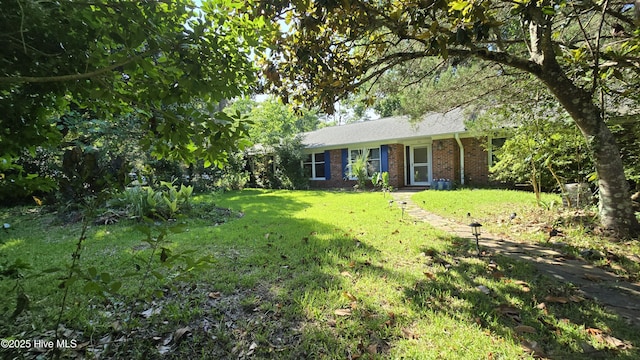 201 Buccaneer Rd, Wilmington, NC 28409 - view of front of property featuring brick siding and a front yard