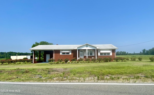 439 Vine Swamp Rd, Kinston, NC 28504 - ranch-style house featuring a front yard, brick siding, and a carport