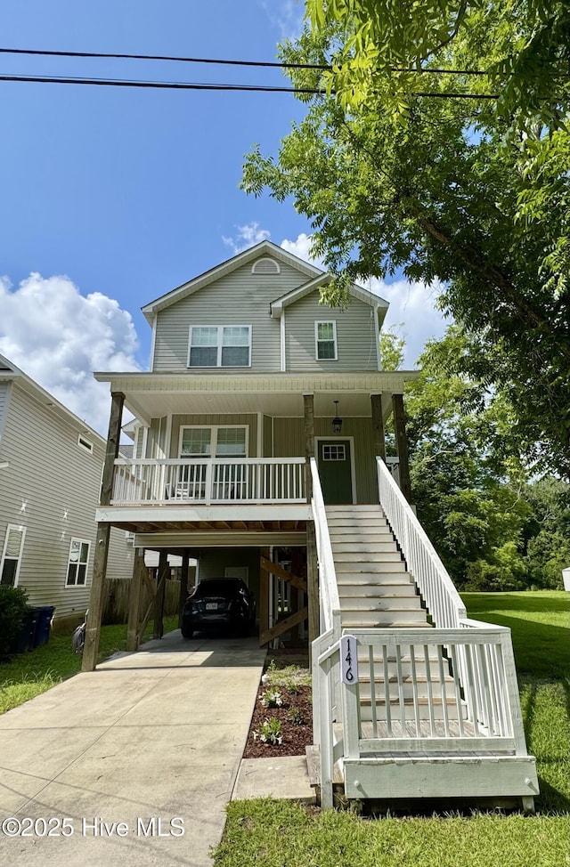 146 Poplar St, Jacksonville, NC 28540 - raised beach house with a carport, covered porch, concrete driveway, and stairs
