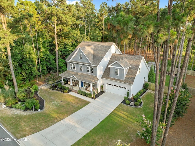 16 Starlit Ln, Pinehurst, NC 28374 - shingle-style home featuring a porch, concrete driveway, a garage, and a shingled roof