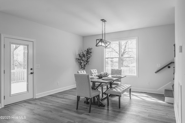 1165 Burning Tree Rd, Pinehurst, NC 28374 - dining area with healthy amount of natural light, wood finished floors, and a chandelier