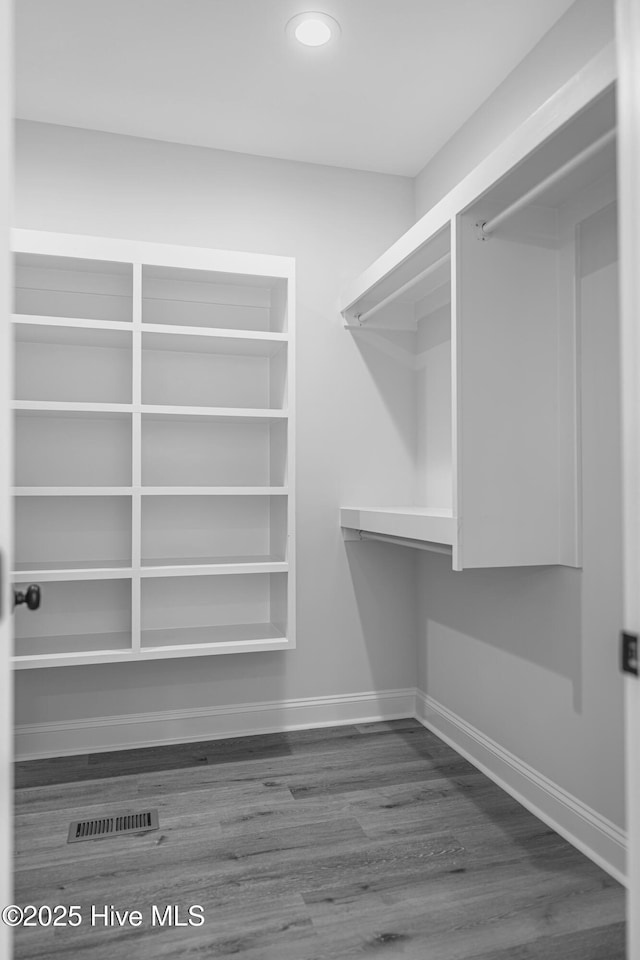 1165 Burning Tree Rd, Pinehurst, NC 28374 - walk in closet featuring wood finished floors