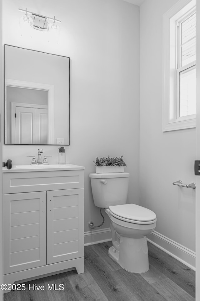1165 Burning Tree Rd, Pinehurst, NC 28374 - half bathroom with wood finished floors and vanity