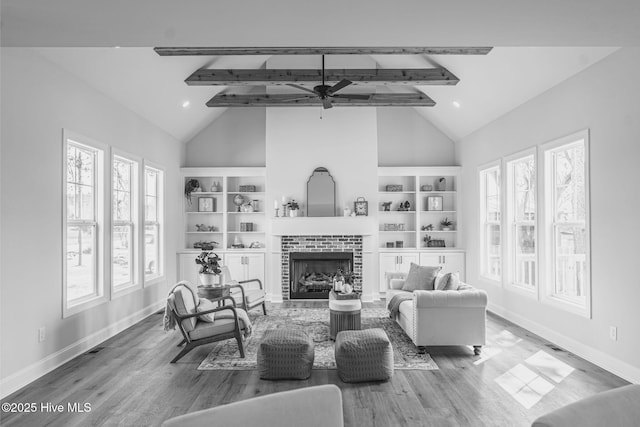 1165 Burning Tree Rd, Pinehurst, NC 28374 - living area with high vaulted ceiling, a ceiling fan, beam ceiling, wood finished floors, and a fireplace