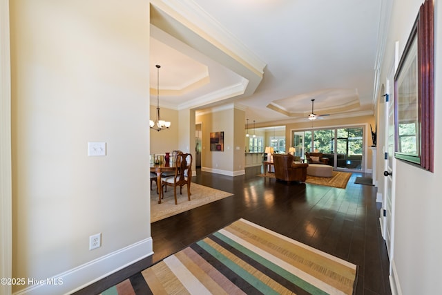 2675 Four Oak Rd, Southport, NC 28461 - foyer with a raised ceiling, hardwood / wood-style flooring, crown molding, a chandelier, and a ceiling fan