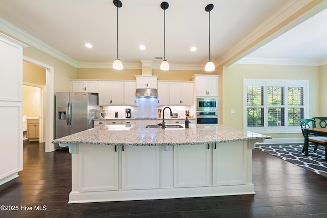 2675 Four Oak Rd, Southport, NC 28461 - kitchen featuring appliances with stainless steel finishes, white cabinetry, a spacious island, dark wood-style flooring, and crown molding