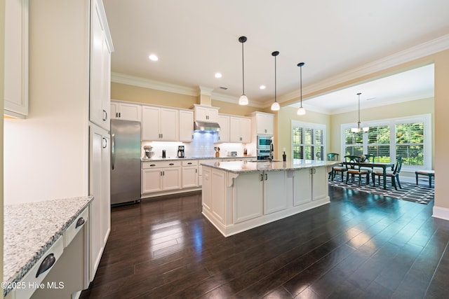 2675 Four Oak Rd, Southport, NC 28461 - kitchen with appliances with stainless steel finishes, white cabinetry, light stone countertops, a kitchen island, and dark wood-type flooring