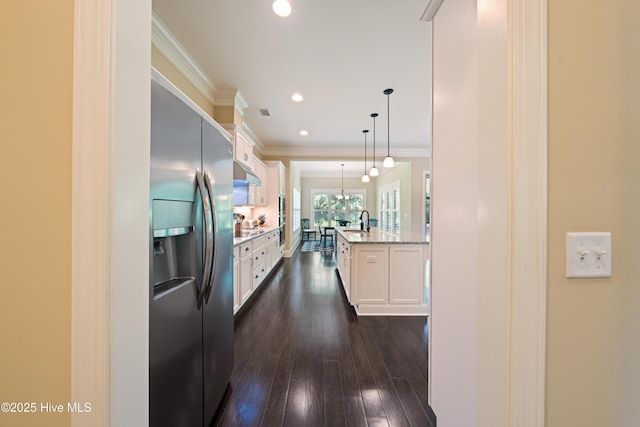 2675 Four Oak Rd, Southport, NC 28461 - kitchen with stainless steel fridge with ice dispenser, white cabinetry, dark wood finished floors, hanging light fixtures, and ornamental molding