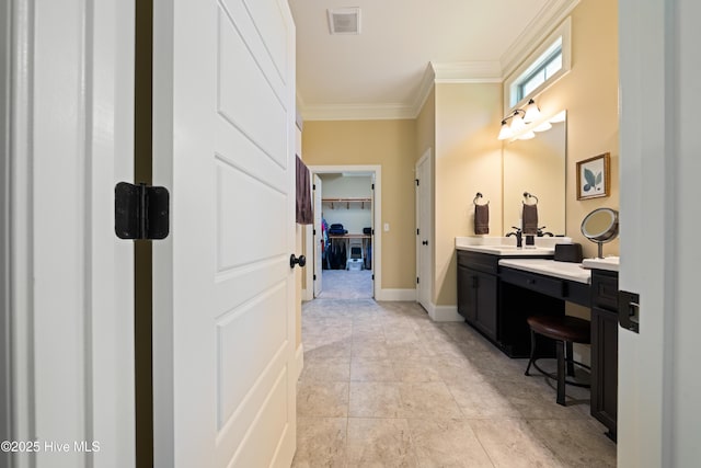 2675 Four Oak Rd, Southport, NC 28461 - bathroom featuring vanity, ornamental molding, a walk in closet, and tile patterned floors