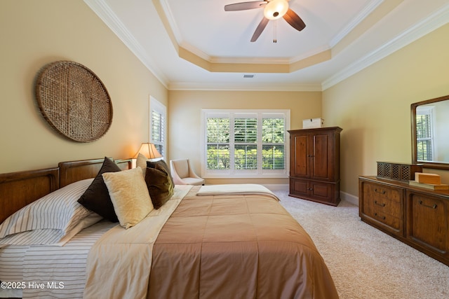 2675 Four Oak Rd, Southport, NC 28461 - bedroom featuring a raised ceiling, light colored carpet, ornamental molding, and a ceiling fan
