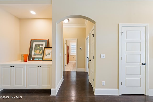2675 Four Oak Rd, Southport, NC 28461 - hall with arched walkways, crown molding, dark wood-type flooring, and recessed lighting