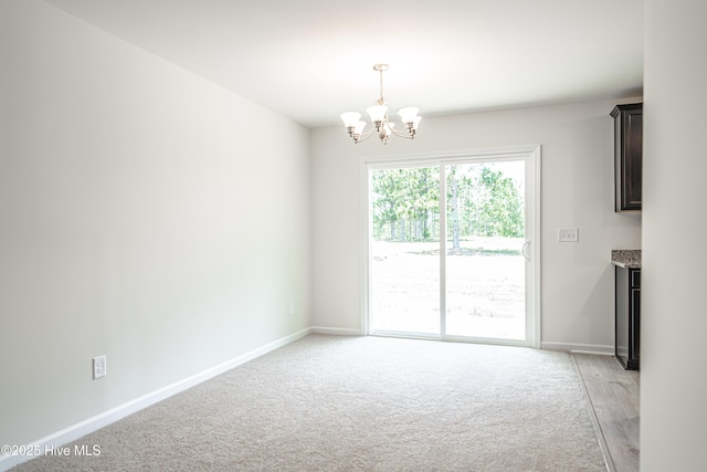 481 Peggy Mill Rd, Hamlet, NC 28345 - spare room featuring a chandelier and light carpet