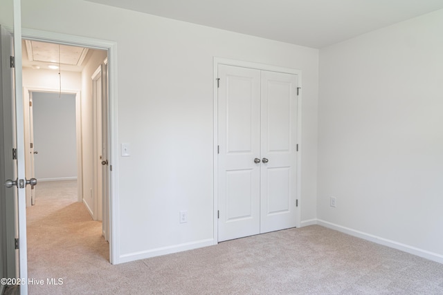 481 Peggy Mill Rd, Hamlet, NC 28345 - unfurnished bedroom featuring attic access, light carpet, and a closet