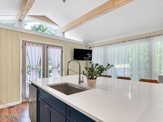 2670 Longleaf Dr SW, Pinehurst, NC 28374 - kitchen featuring light wood finished floors, light countertops, dishwasher, french doors, and wood walls
