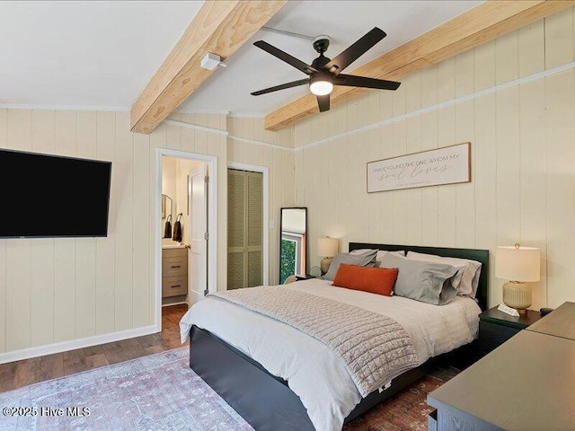 2670 Longleaf Dr SW, Pinehurst, NC 28374 - bedroom featuring wood finished floors, beam ceiling, a ceiling fan, connected bathroom, and wood walls