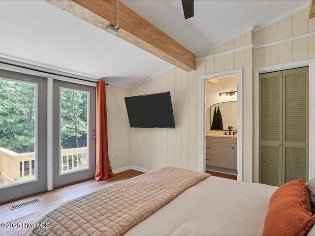 2670 Longleaf Dr SW, Pinehurst, NC 28374 - bedroom featuring ensuite bathroom, access to outside, wood finished floors, and ceiling fan
