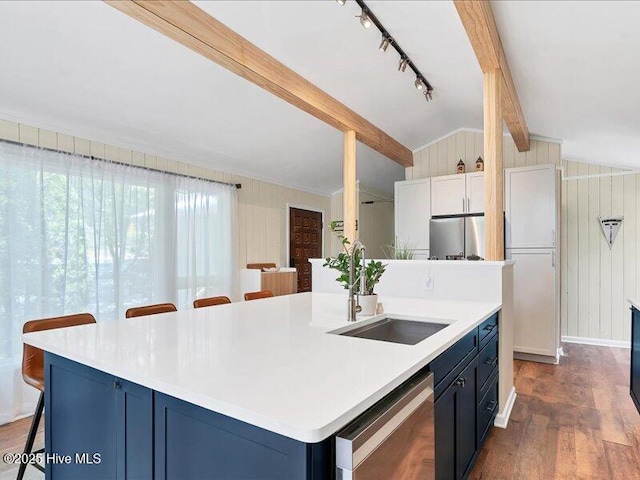 2670 Longleaf Dr SW, Pinehurst, NC 28374 - kitchen with stainless steel dishwasher, refrigerator, dark wood-style floors, a breakfast bar, and a center island with sink