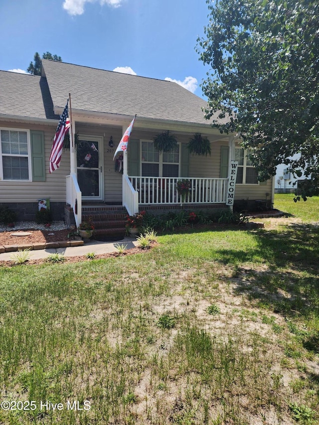 207 Cherry Rd, Southport, NC 28461 - view of front of home featuring a porch, a front yard, and crawl space