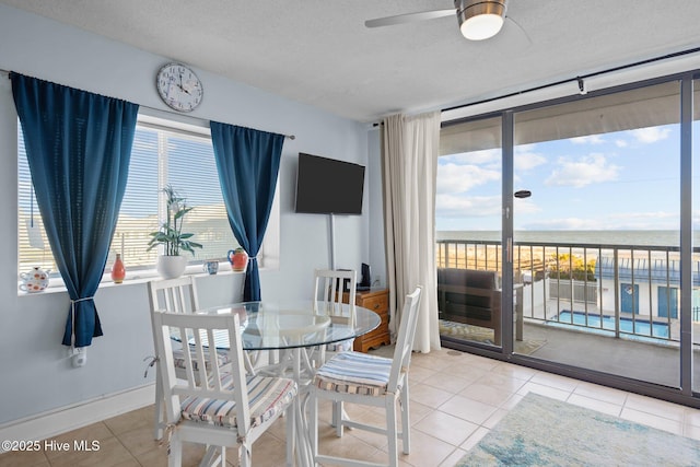 901 Lake Park Blvd S Unit 201, Carolina Beach, NC 28428 - dining room featuring tile patterned flooring, a ceiling fan, and a textured ceiling