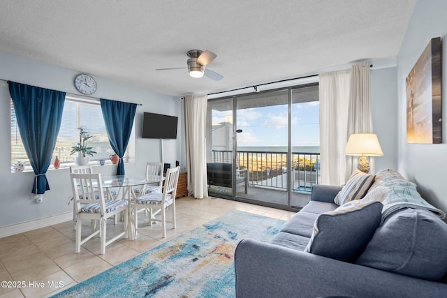 901 Lake Park Blvd S Unit 201, Carolina Beach, NC 28428 - tiled living area with a ceiling fan and a textured ceiling