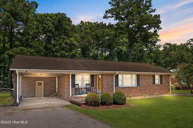 116 Waterside Dr, Bath, NC 27808 - single story home featuring asphalt driveway, a porch, brick siding, a lawn, and an attached carport
