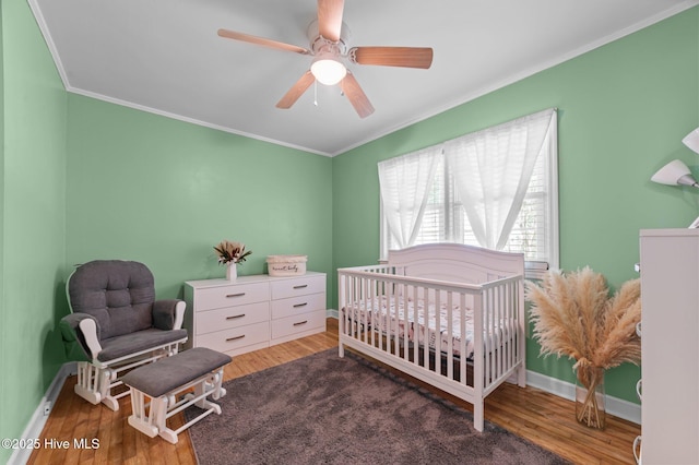 116 Waterside Dr, Bath, NC 27808 - bedroom with crown molding, wood finished floors, a nursery area, and a ceiling fan